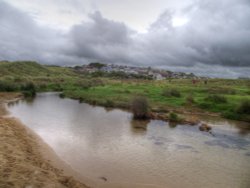 The stream at Holywell bay beach Wallpaper