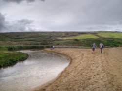 The stream and beach at Holywell bay Wallpaper