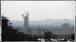 The old mill stands sentinel in the evening light. Wallpaper