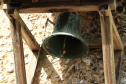 Bell on outside wall of St. Botolph's Church, Swyncombe Wallpaper