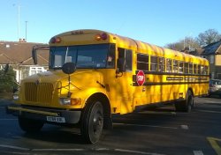 the big yellow bus comes to the school Wallpaper