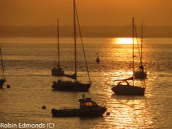 Boats in the setting sun at Yarmouth, Isle of Wight Wallpaper