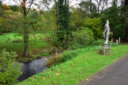 The Tilling Bourne River Running by Albury Village Hall in Surrey Wallpaper