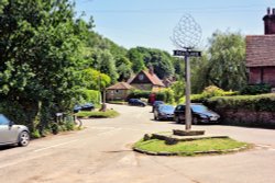 The Village Sign at the Centre of Peaslake, Surrey Wallpaper