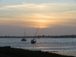 Amazing sunset over Christchurch harbour from Mudeford Quay including boats Wallpaper