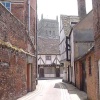 A view of Tewkesbury Abbey from with a street in the town of Tewkesbury.