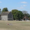 Guildhall museum in Priory Park, Chichester, with cricketers practicing before their match