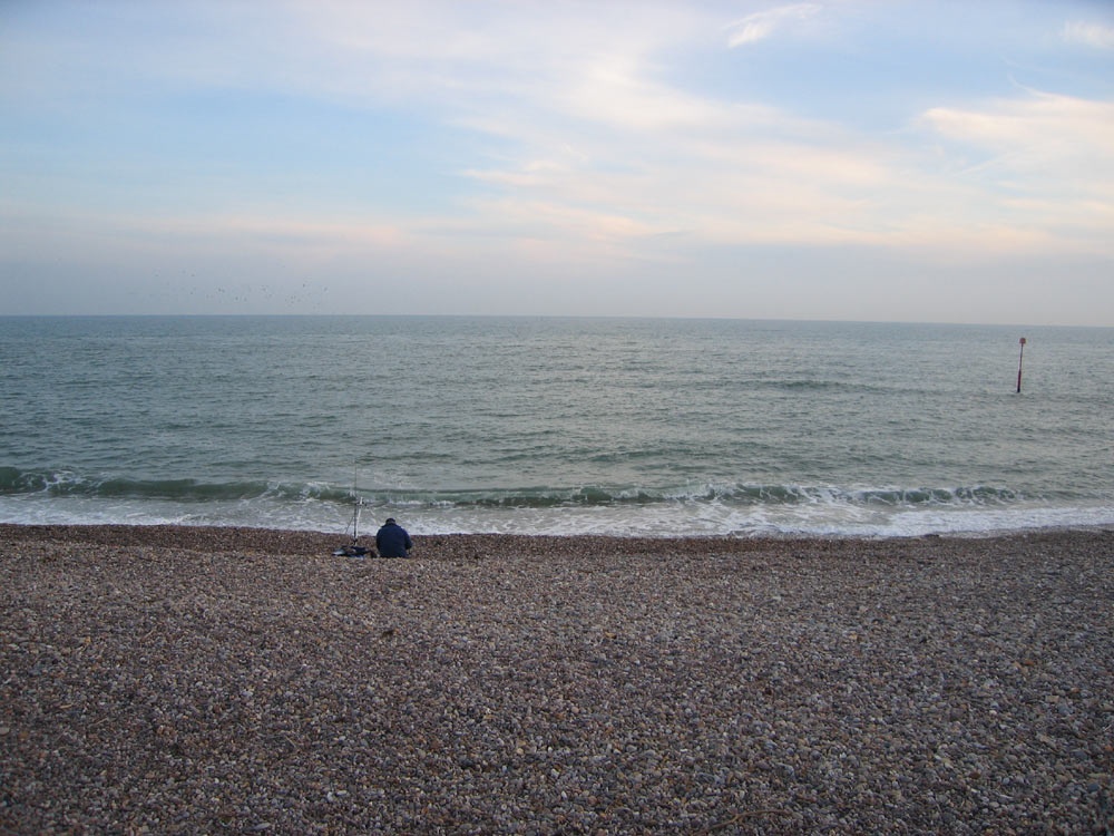 A fisherman along the seafront at West Bay, Dorset