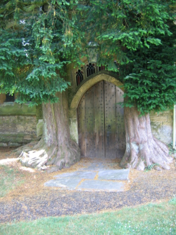 North Porch of St Edwards Church, flanked by yew trees. Stow on the Wold, Gloucestershire cotswolds