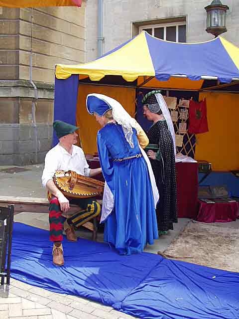 A lute player with two ladies at Gloucester Medieval Fayre in June 2006.