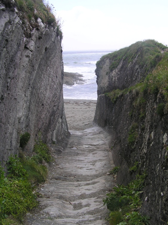 Rock-cut path to the beach at Lansallos cove in Cornwall