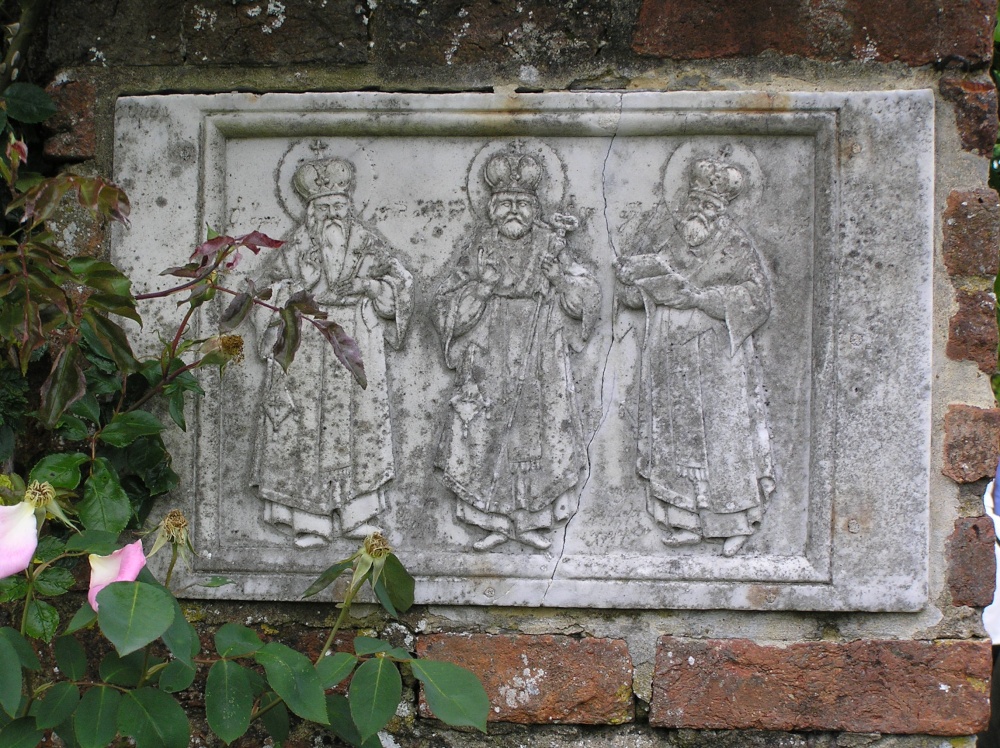 A wall plaque of three kings at Sissinghurst castle gardens