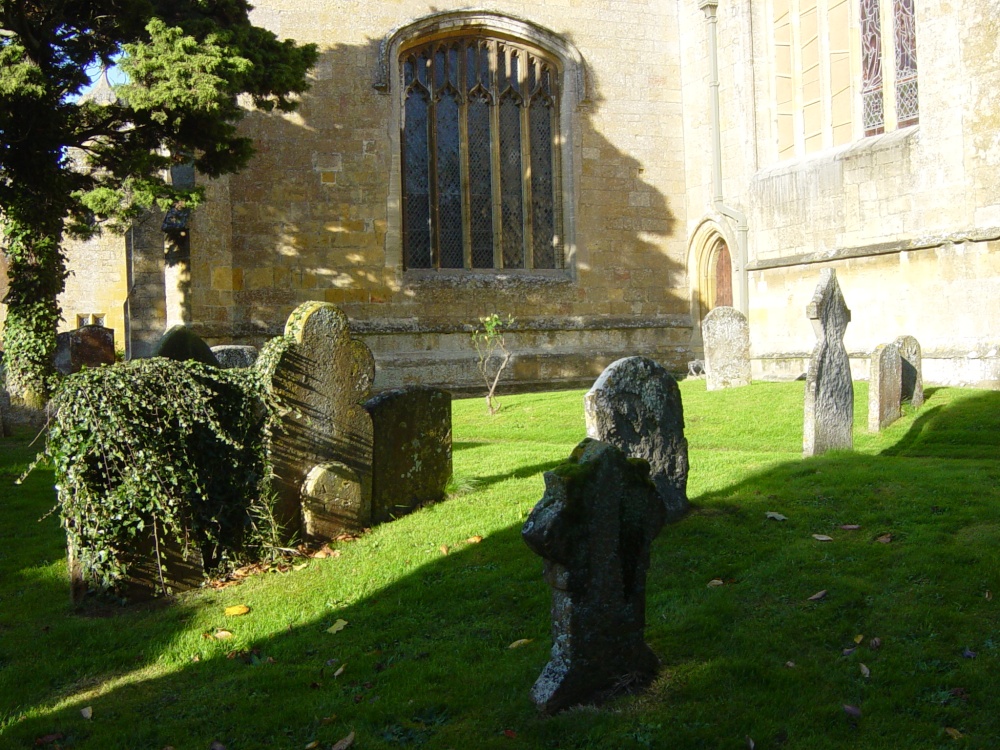 Churchyard in sun with shadow on graves