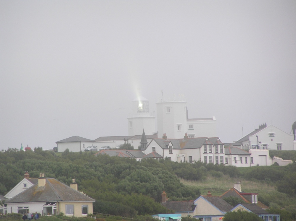 The beam of Lizard lighthouse reflects off the fog