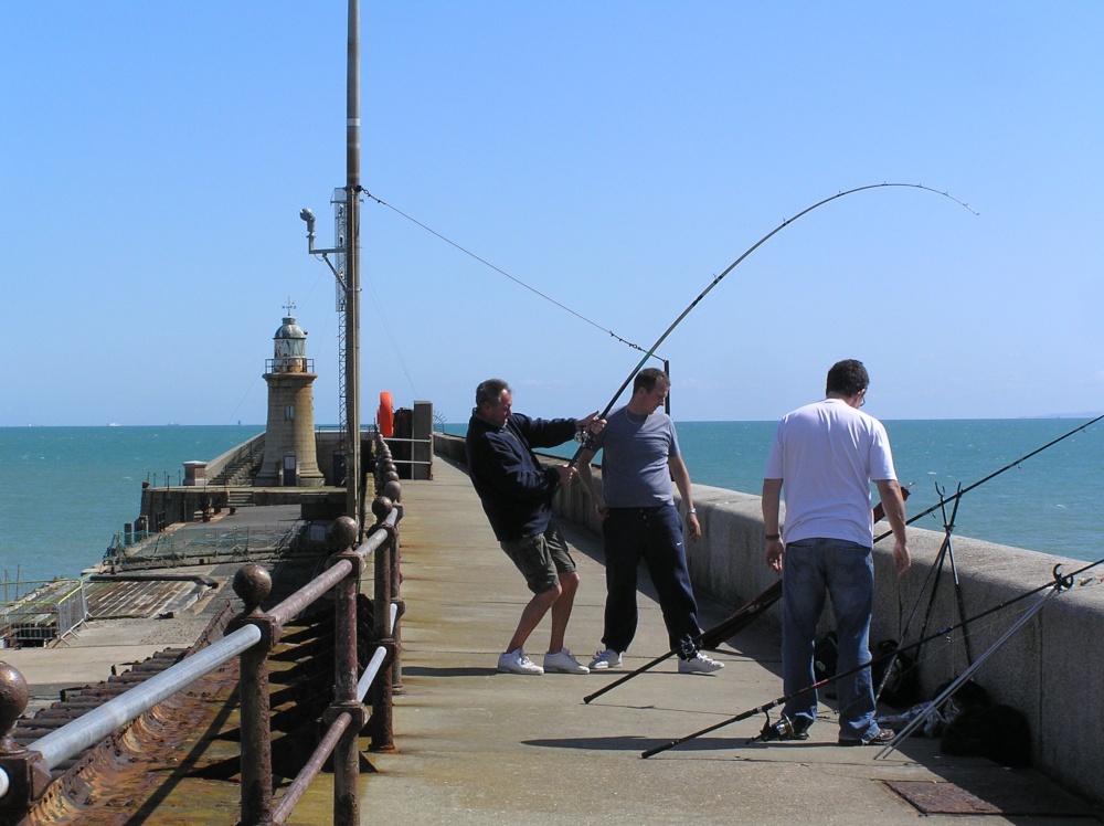 Fishing off the harbour wall at Folkestone