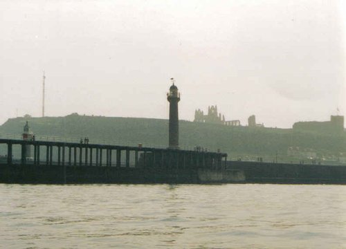 A view of Whitby Abbey taken from a boat entering the harbour