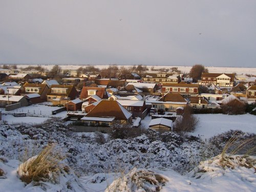 view of Camber, East Sussex from the Sand dunes. Looking over to Romney Marsh