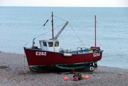 Fishing boat on beach in Beer