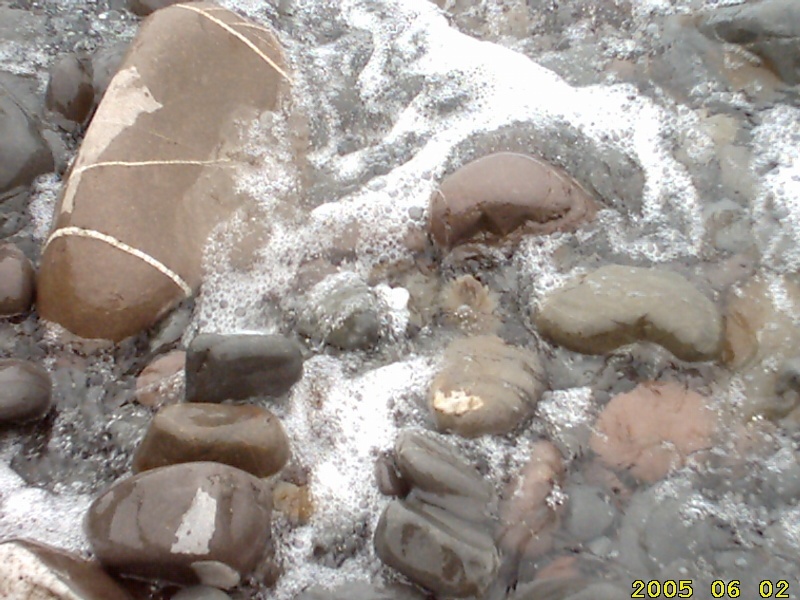 A wave bubbling through the pebbles on Clovelly beach