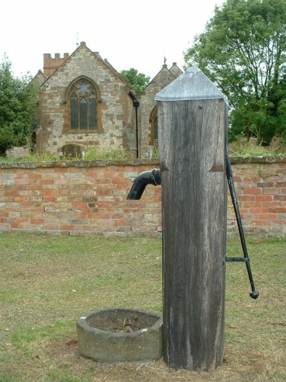 The All Saints Church in Harbury, Warwickshire, with a very old well...