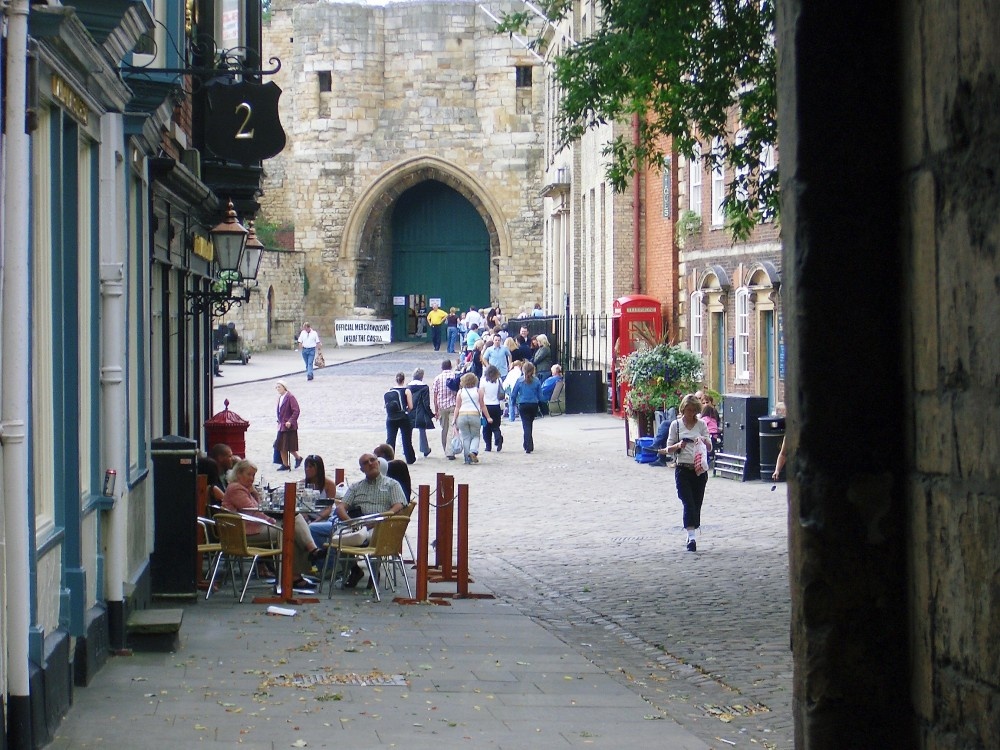 Local types have a drink while tourists take in the sights at the top of cobbled Steep Hill.