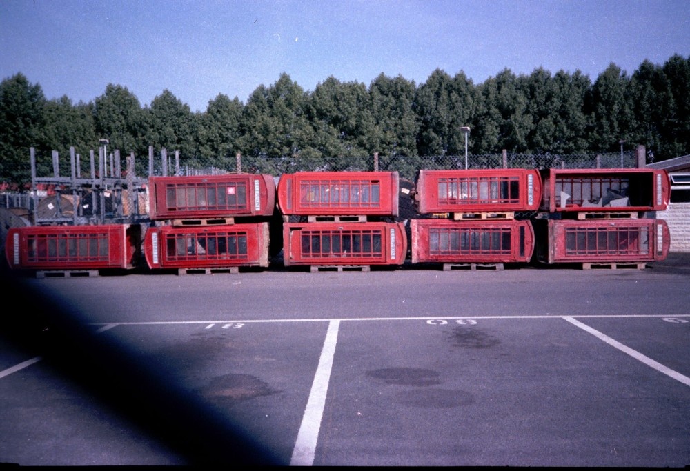 Taunton's old BT yard piled up with discarded Phone boxes.