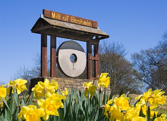 Photograph of Old mill wheel at the turn off for Benholm from the A92 coastal road.