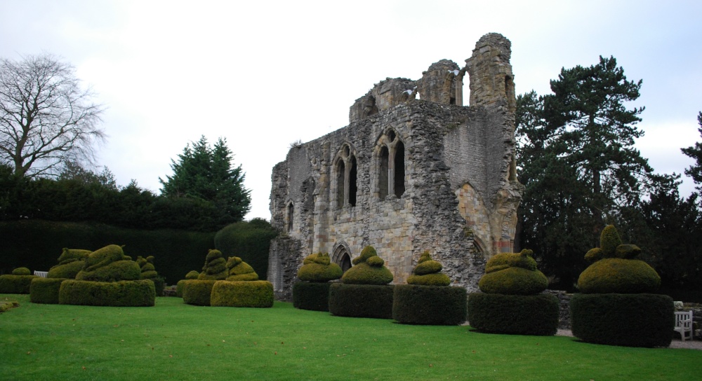 Photograph of Wenlock Priory with animal shape trees