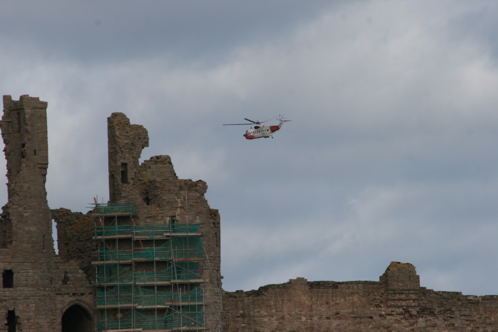 Dunstanburgh Castle with RNLI rescue helicopter