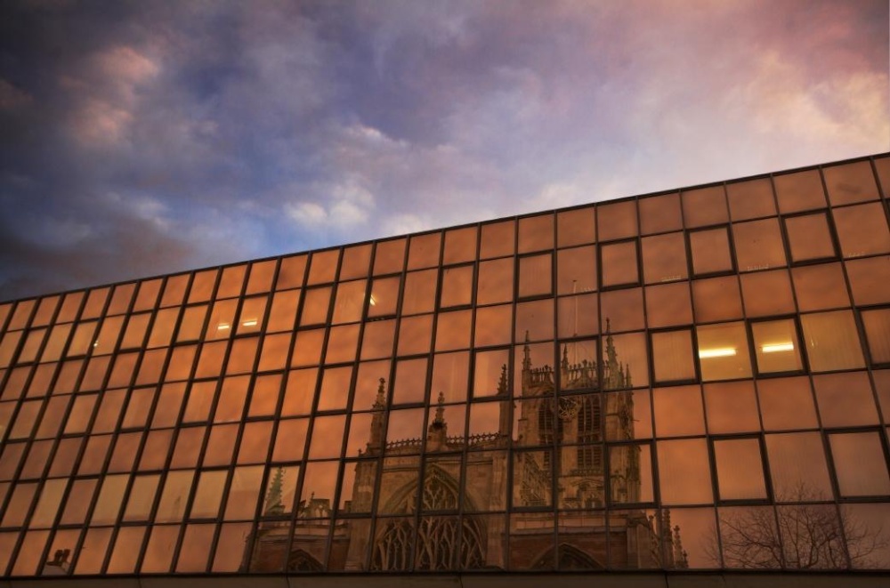 Holy Trinity Church reflecting in bank windows