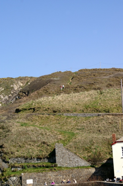 Couple walking down the hill path.