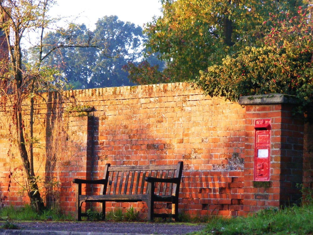 Photograph of Bench, letter box, dawn.