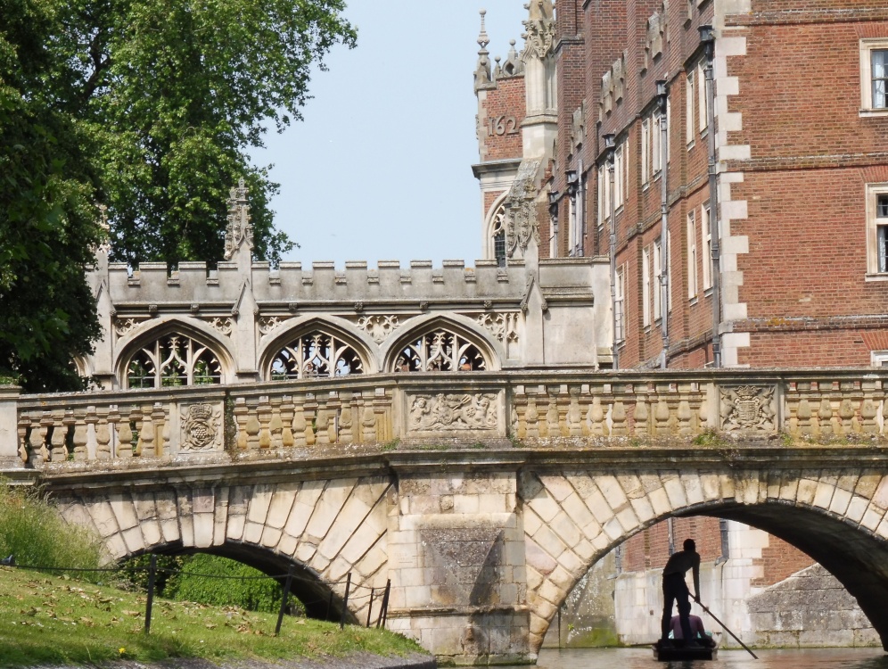 Punting under a bridge, on the River Cam in Cambridge