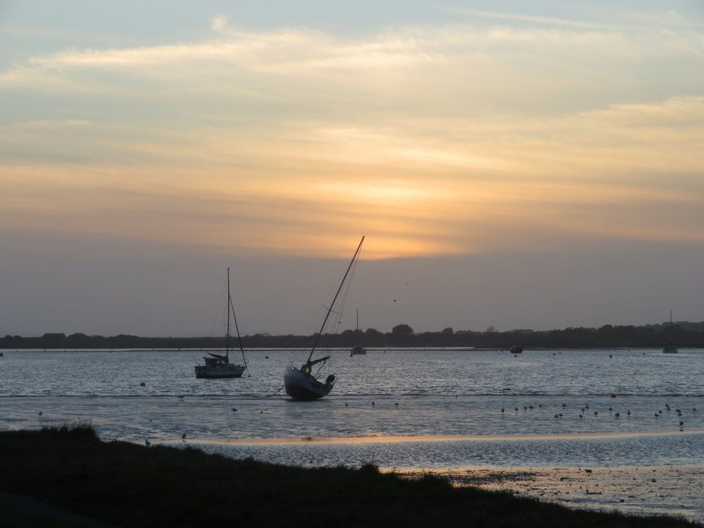 Amazing sunset over Christchurch harbour from Mudeford Quay including boats